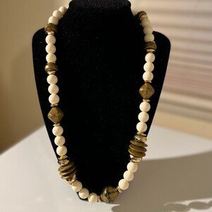 White and brown beaded necklace with gold accents